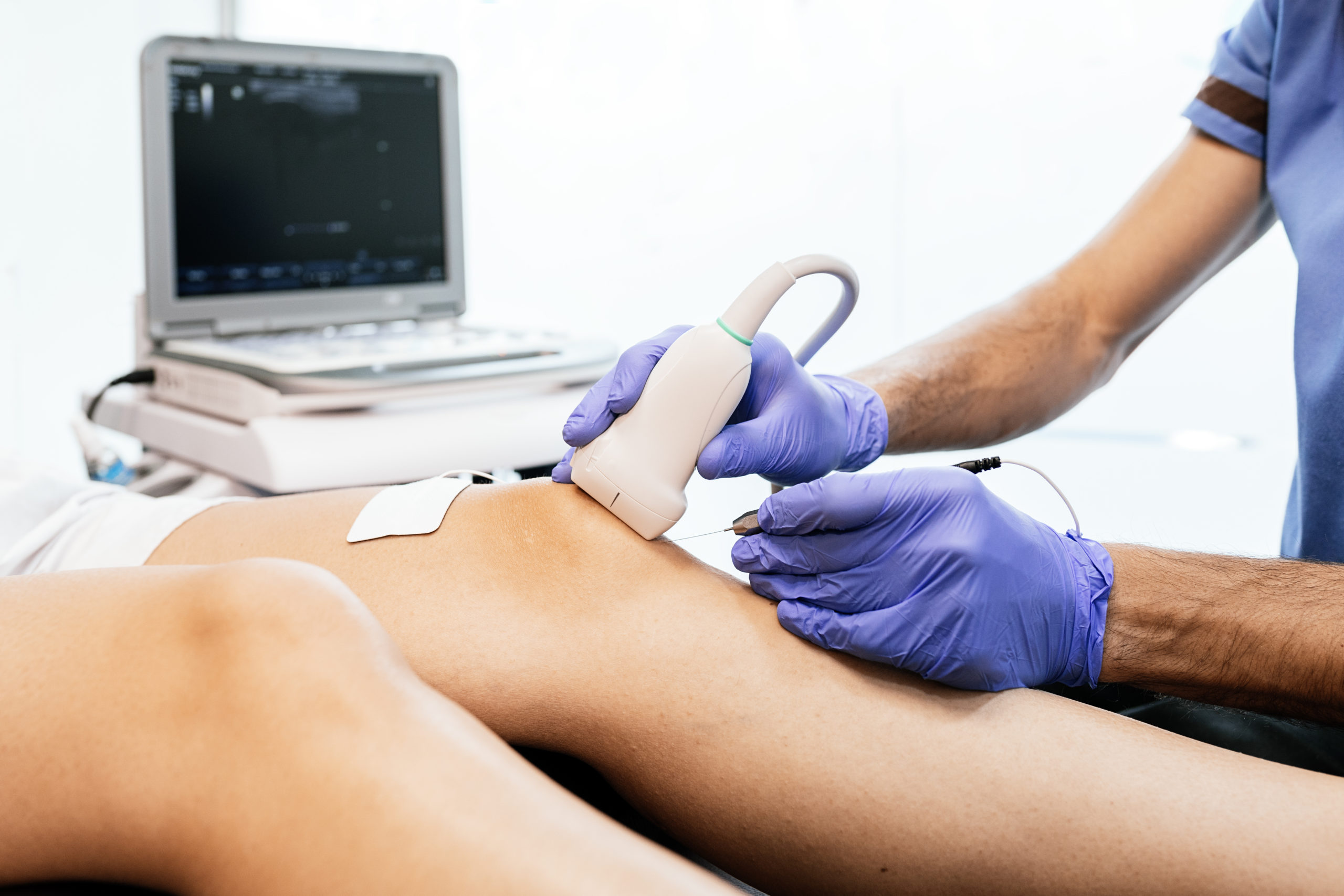 giving knee therapy to a woman