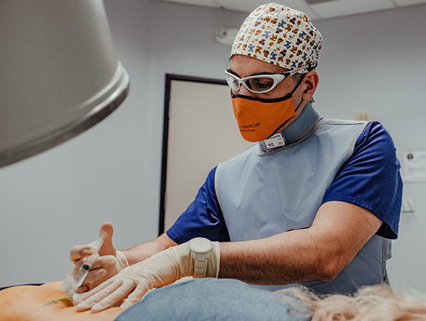 Doctor performing a procedure on a patient